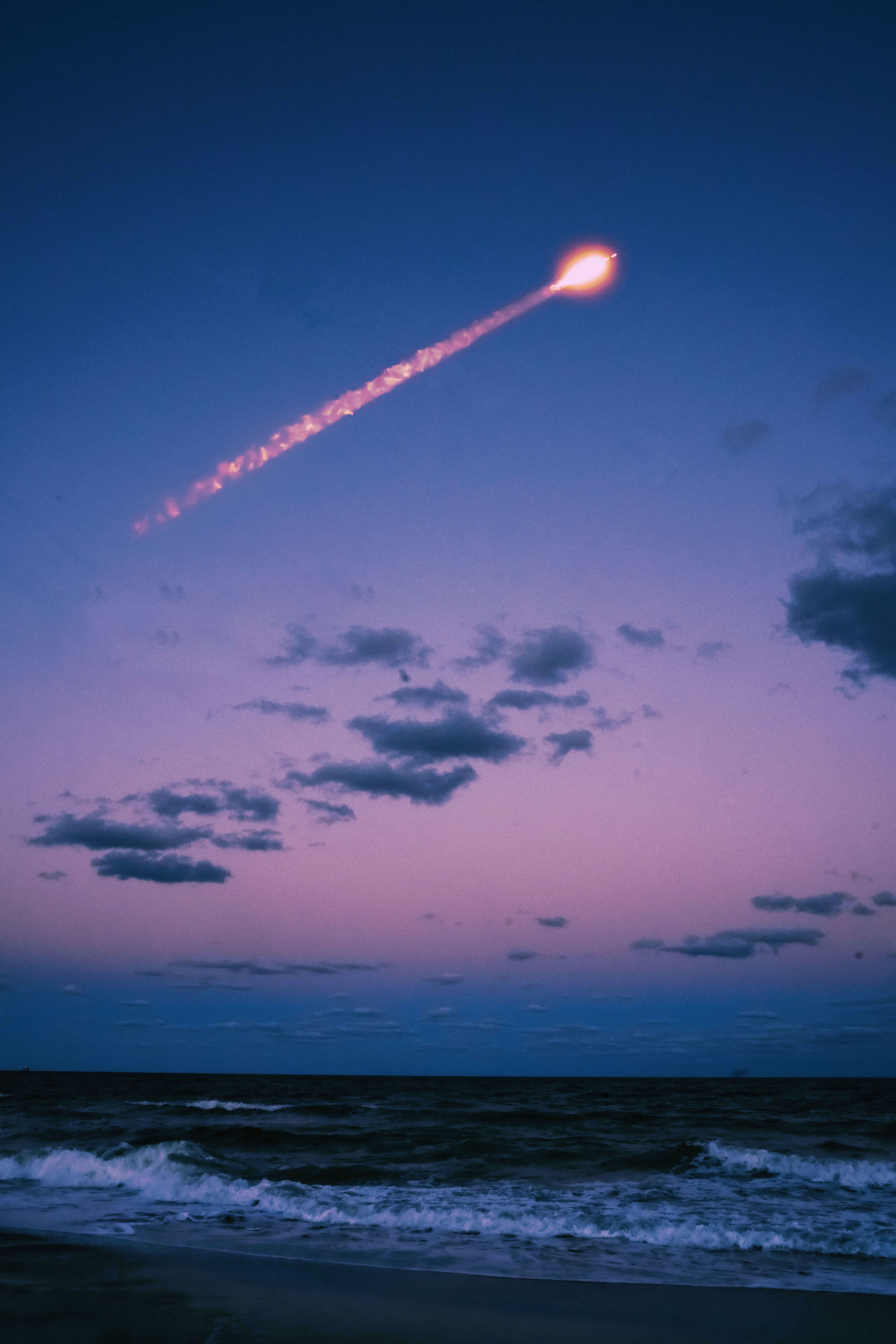 a rocket flying over the ocean